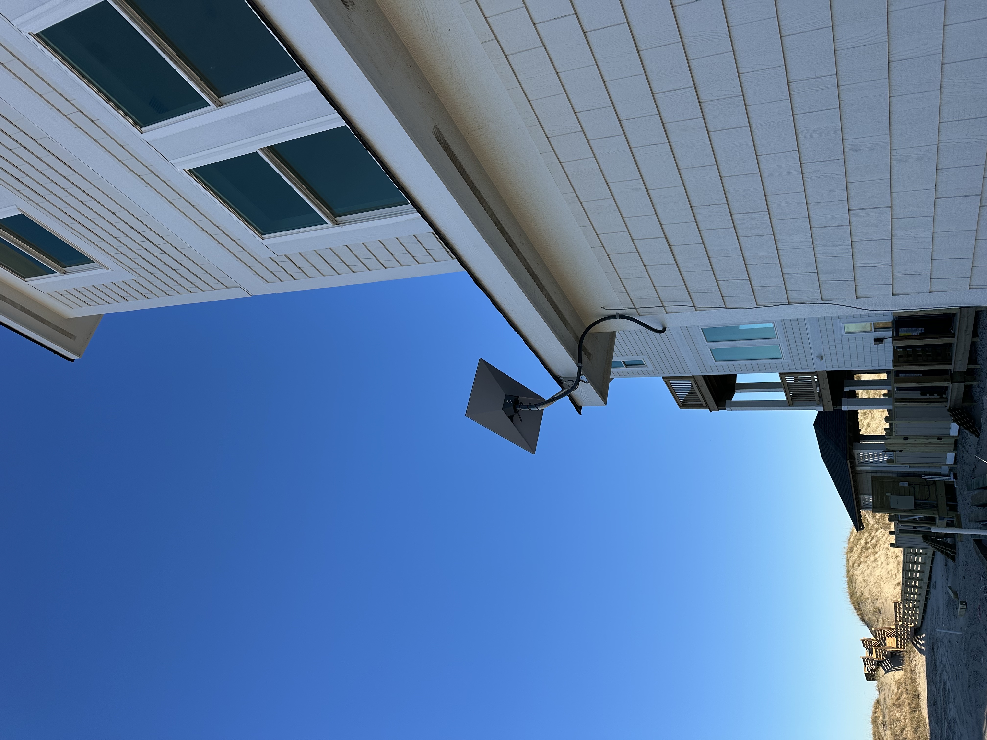 satellite wall mount on beachfront home with ocean dunes â Outer Banks satellite internet installation